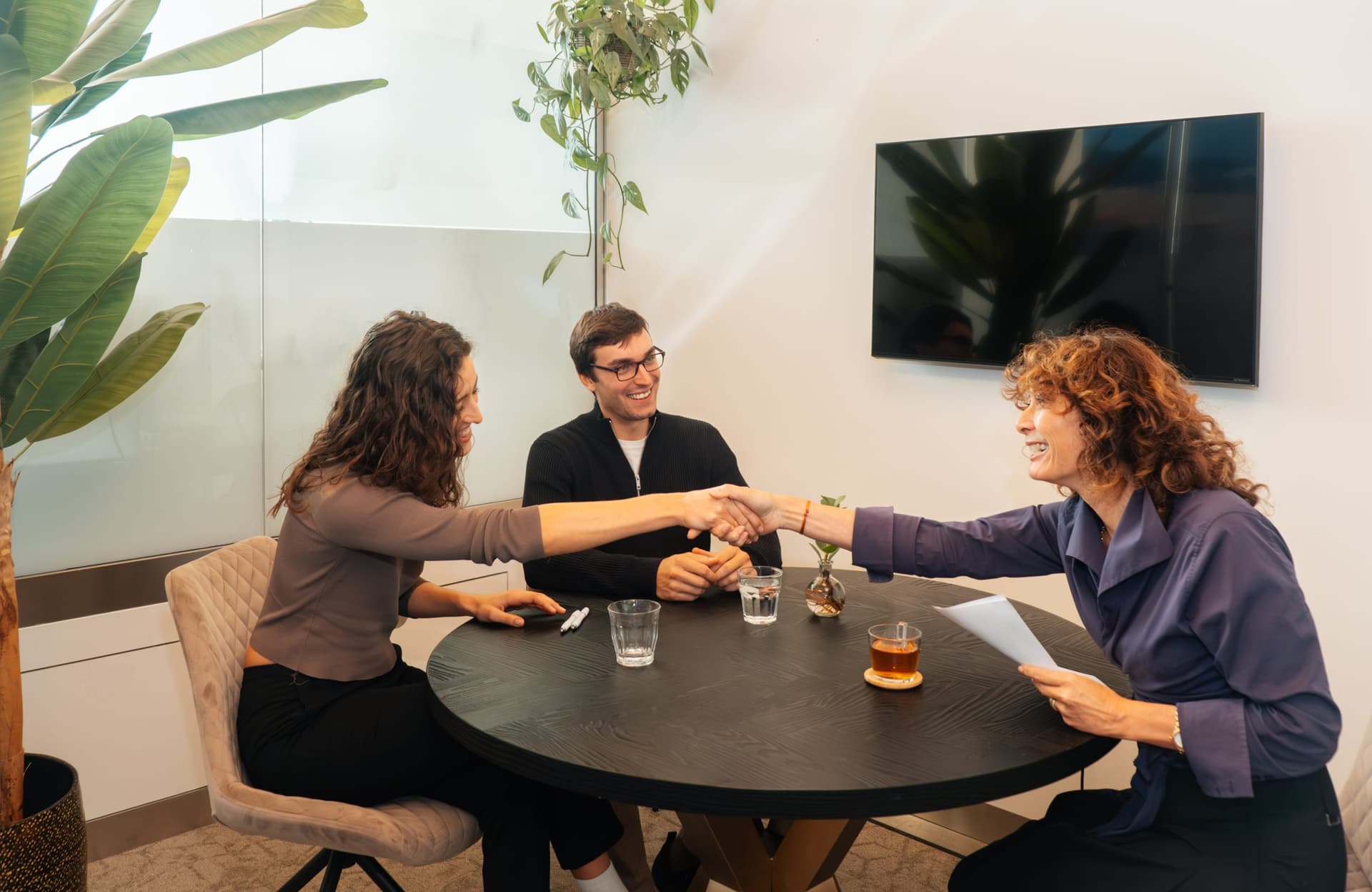 A person working on a laptop in a modern apartment